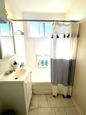 a bathroom with a shower curtain and a sink at Minimalist 1 bed by Airport & Old Town in San Diego