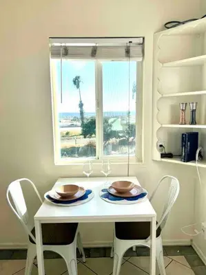 a white table with two chairs and a window at Minimalist 1 bed by Airport & Old Town in San Diego