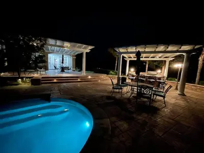 a swimming pool in front of a house at night at Temecula Wine Country Villa in Temecula