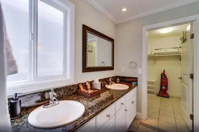 a bathroom with two sinks and a large window at Mission Beach Townhome Getaway in San Diego