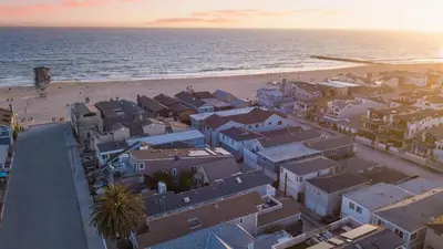 an aerial view of a beach with houses and the ocean at Surfrider I by AvantStay Walk to the Beach Patio in Newport Beach