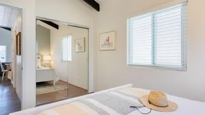 a bedroom with a bed with a hat on it at Surfrider II by AvantStay Walk to the Beach Balcony in Newport Beach