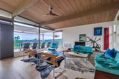 a living room with a table and chairs and a couch at The Helix House - Pool & Mountain Views in La Mesa