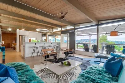 a living room with a couch and a table at The Helix House - Pool & Mountain Views in La Mesa