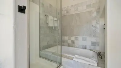 a bathroom with a shower and a bath tub at The Oliver - Pacific Beach Hideaway in San Diego