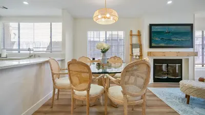 a dining room with a table and chairs and a fireplace at The Oliver - Pacific Beach Hideaway in San Diego