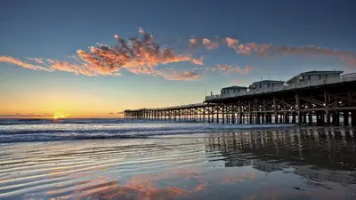 a pier on the beach with the ocean at The Oliver - Pacific Beach Hideaway in San Diego