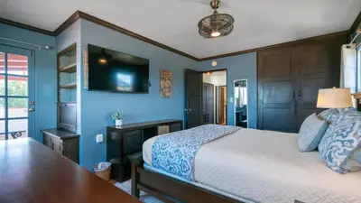 a bedroom with a bed and a tv on the wall at Mediterranean-Style Villa in Point Loma in San Diego