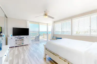 a bedroom with a bed and a flat screen tv at Bayside Retreat in San Diego