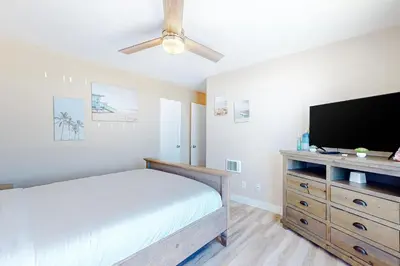 a bedroom with a bed and a flat screen tv at Bayside Retreat in San Diego
