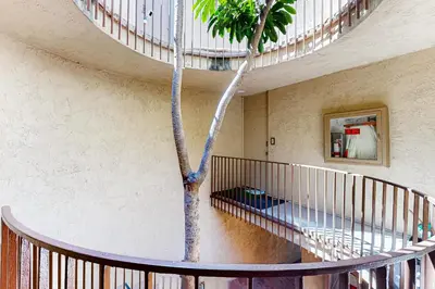 a winding staircase with a tree in a building at Bayside Retreat in San Diego