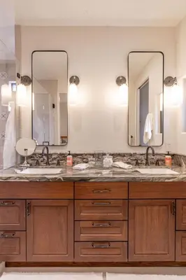 a bathroom with two sinks and two mirrors at Enchanting Encinitas Oceanview Casita in Encinitas