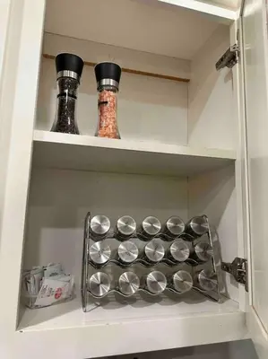 a cupboard with two bottles and pans in it at HC Accessible 4 Bed 3 Bath with Sparkling Pool and Spa-we have lifts and roll in shower in Santee
