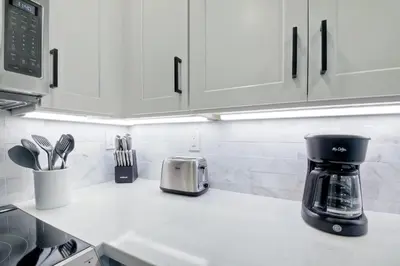 a kitchen counter with a coffee maker on the counter at Beautifully Remodeled - Private Balcony - Pool View - BBQ Access - Gated Reserved Parking in Encinitas