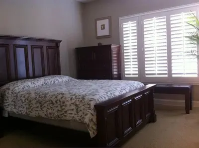 a bedroom with a bed and a dresser and a window at Laguna Condo w/ Pool/Jacuzzi and Attached Garage in Laguna Niguel
