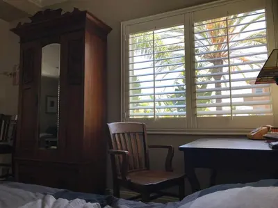 a bedroom with a chair and a desk and a window at Laguna Condo w/ Pool/Jacuzzi and Attached Garage in Laguna Niguel