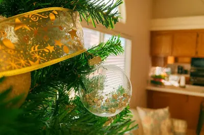 a christmas tree with a glass ornament on it at Western Horizon Home in Hemet