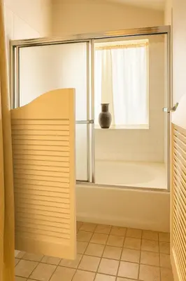 a bathroom with a shower with a window and a tub at Western Horizon Home in Hemet