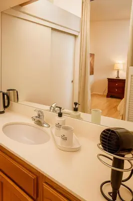 a bathroom with a sink and a mirror at Western Horizon Home in Hemet