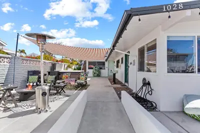 a patio of a house with an umbrella at Amazing Place by the Sea - O'side Palms in Oceanside