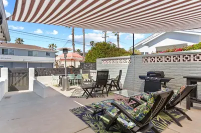 a patio with chairs and tables and a grill at Amazing Place by the Sea - O'side Palms in Oceanside