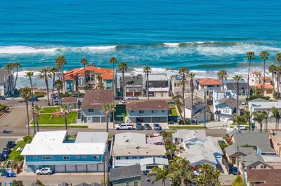an aerial view of a beach with houses and the ocean at California Dreamin at O'side Palms in Oceanside