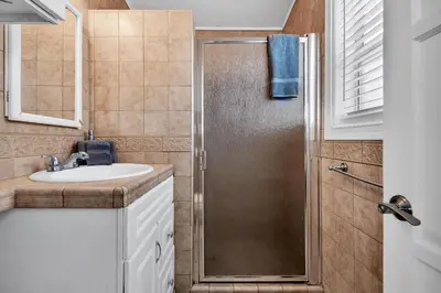 a bathroom with a shower and a sink at Stunning Beach Haven! Steps to the Beach & Pet Friendly! in San Diego