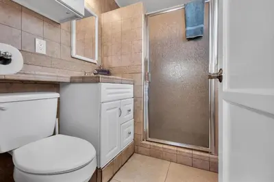a bathroom with a toilet and a shower at Stunning Beach Haven! Steps to the Beach & Pet Friendly! in San Diego