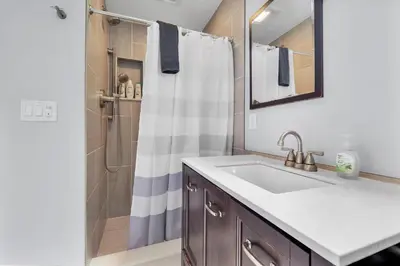 a bathroom with a sink and a shower at Stunning Beach Haven! Steps to the Beach & Pet Friendly! in San Diego