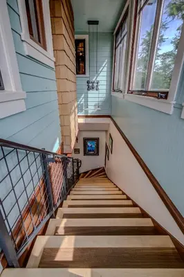 a staircase in a home with windows at The Craftsman Coastal Cottage in Leucadia in Encinitas