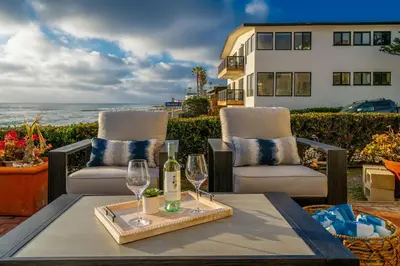 a table with two glasses and a bottle of wine at Oceanfront Townhome with Breathtaking Views in San Diego