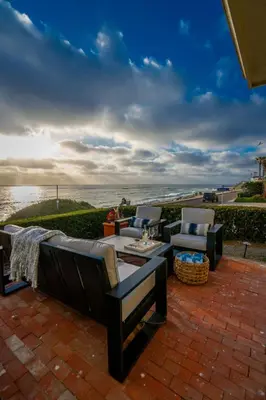 a patio with two chairs and a table with a view of the water at Oceanfront Townhome with Breathtaking Views in San Diego
