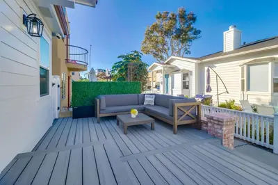 a patio with a couch and a table at Breezy Bayside Cottage in San Diego