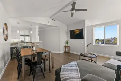 a kitchen and living room with a table and a couch at Prime Mission Beach Getaway in San Diego