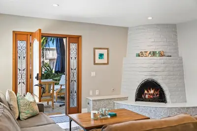 a living room with a fireplace and a couch at Coastal Chic at Windansea in San Diego