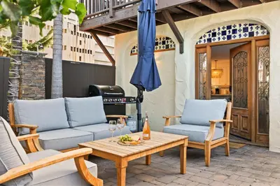 a patio with two chairs and a table and an umbrella at Coastal Chic at Windansea in San Diego