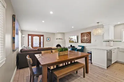 a kitchen and living room with a table and a couch at Coastal Chic at Windansea in San Diego