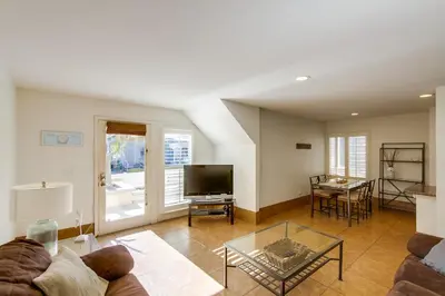 a living room with a couch and a television at Massive Beach Home with Ocean View & Amazing Rooftop in San Diego