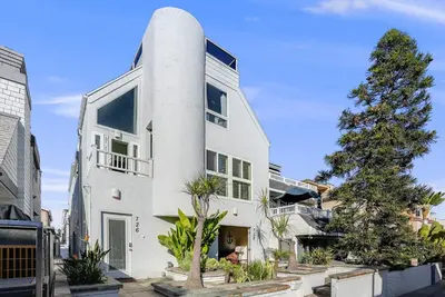 a white house with a tall white tower at Massive Beach Home with Ocean View & Amazing Rooftop in San Diego