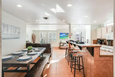 a kitchen and living room with a table and chairs at Massive Beach Home with Ocean View & Amazing Rooftop in San Diego