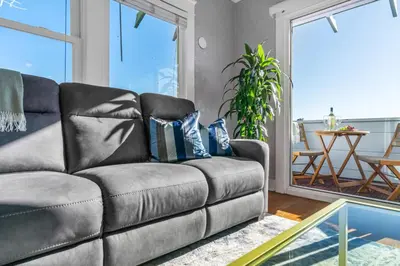 a leather couch in a living room with a table at Bankers Hill Hideaway with AC Views and Parking in San Diego