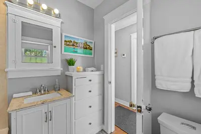 a white bathroom with a sink and a toilet at Bankers Hill Hideaway with AC Views and Parking in San Diego