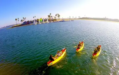 three people in kayaks in a body of water at The Boardwalk Hotel in San Diego