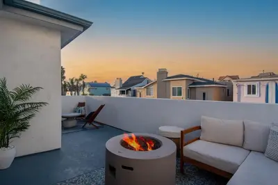 a living room with a couch and a fire pit on a balcony at The Boardwalk Hotel in San Diego