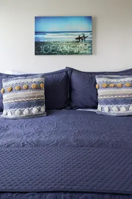 a blue couch with two pillows on it at Oceanside Beach Condos in Oceanside