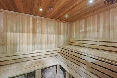 a sauna with wooden benches in a room at Oceanside Beach Condos in Oceanside
