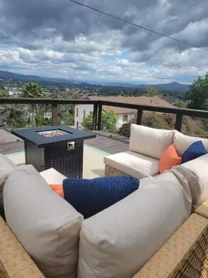 a living room with a couch and a table on a balcony at Hidden Oasis Near Safari - Wineries - Lakes in Escondido