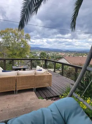 a balcony with two wicker couches on a wooden deck at Hidden Oasis Near Safari - Wineries - Lakes in Escondido
