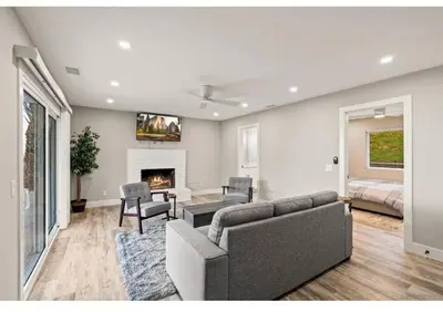 a living room with a couch and a fireplace at Hidden Oasis Near Safari - Wineries - Lakes in Escondido