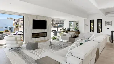 a living room with white furniture and a flat screen tv at Steps to BeachShops Oceanview Hot TubFirepit Moonlight Modern by AvantStay in Encinitas